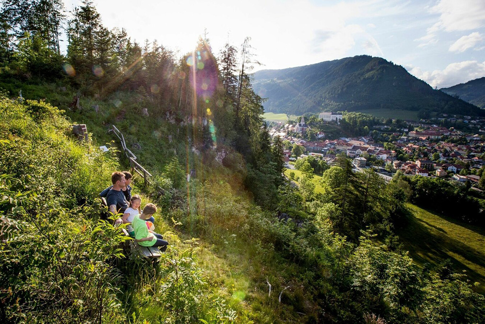 Familie bei einer Rast mit Blick auf Murau – Sommerurlaub mit Kindern Österreich